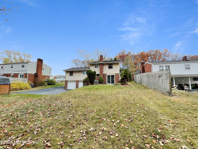 exterior space with a lawn and a garage