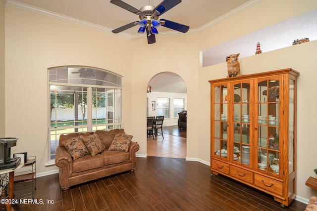 living room with ornamental molding, ceiling fan, a textured ceiling, and dark hardwood / wood-style flooring