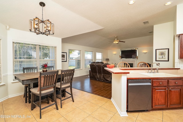 kitchen featuring a textured ceiling, ceiling fan with notable chandelier, pendant lighting, light hardwood / wood-style floors, and sink