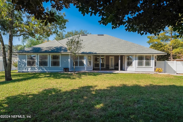 rear view of house with a yard