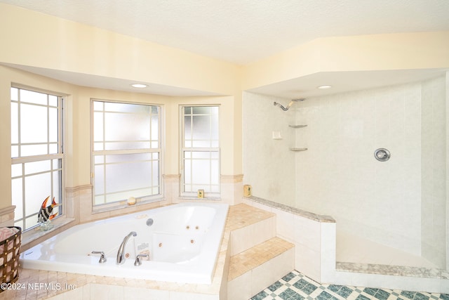 bathroom featuring a textured ceiling, independent shower and bath, and tile patterned flooring