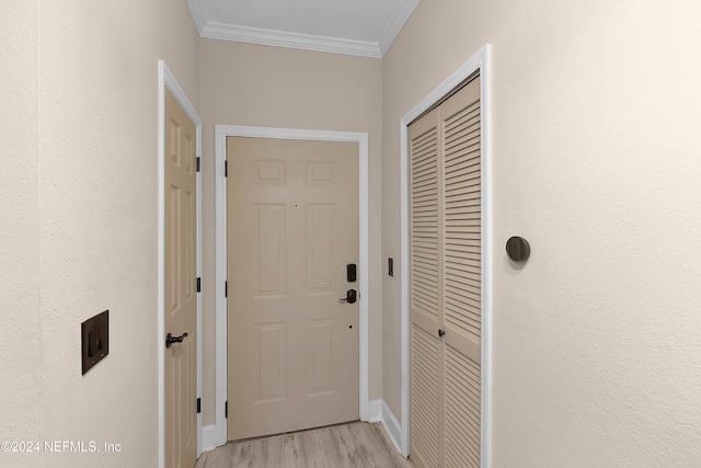 doorway to outside featuring light hardwood / wood-style floors and ornamental molding