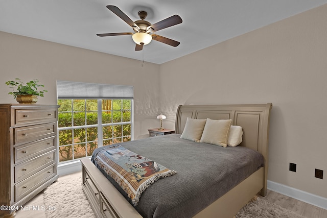 bedroom with ceiling fan and light hardwood / wood-style flooring