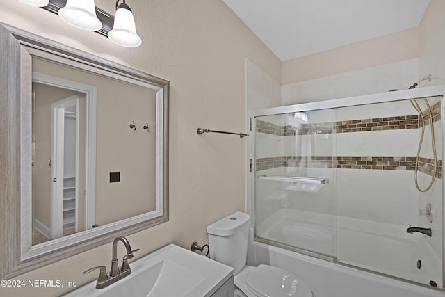 full bathroom featuring vanity, toilet, and combined bath / shower with glass door