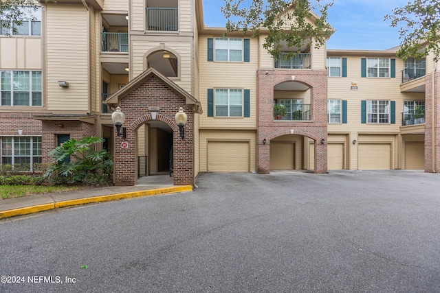 view of front of property with a balcony and a garage