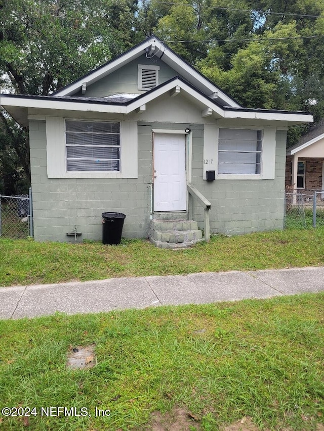 bungalow-style home with a front lawn