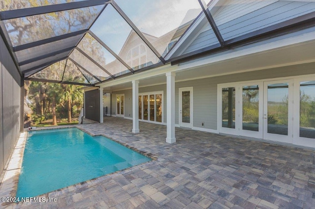 view of pool with a patio area, french doors, and a lanai