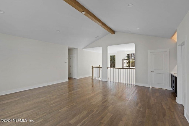 unfurnished living room with lofted ceiling with beams, a chandelier, and dark wood-type flooring