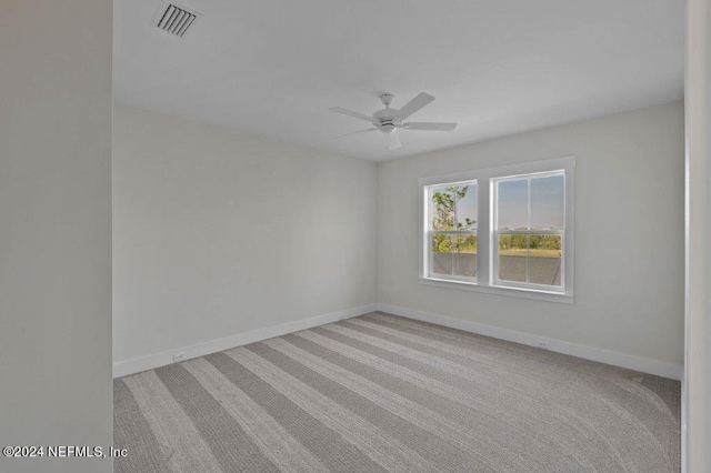 carpeted empty room with ceiling fan