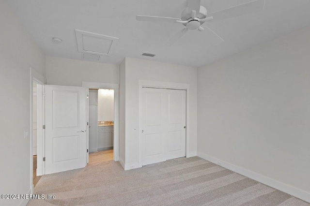 unfurnished bedroom featuring light colored carpet, a closet, and ceiling fan