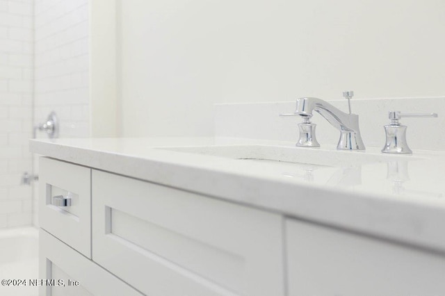 bathroom featuring vanity and a washtub