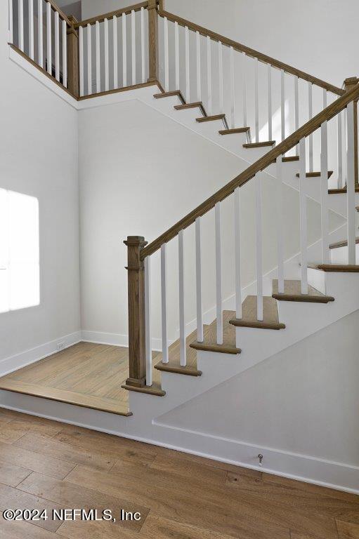 stairway with hardwood / wood-style flooring