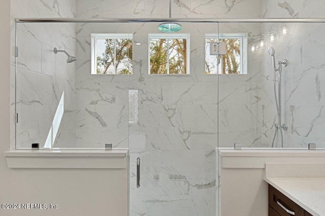 bathroom featuring vanity and a shower with shower door