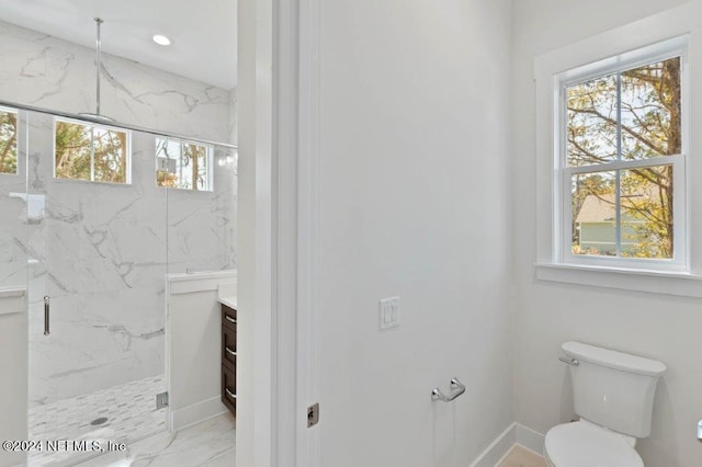 bathroom featuring vanity, toilet, and walk in shower