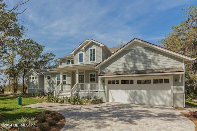 96613 Bay View Dr, Fernandina Beach, FL 32034 - view of front of home featuring covered porch, decorative driveway, and a garage
