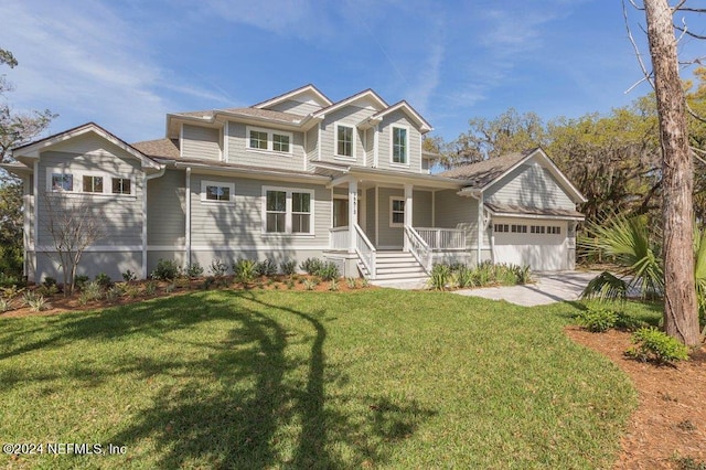 96613 Bay View Dr, Fernandina Beach, FL 32034 - view of front of house featuring covered porch, an attached garage, and a front yard