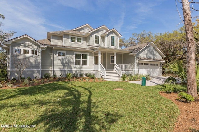 view of front of property with covered porch, a front yard, and a garage