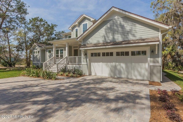 view of front of house with a porch and a garage