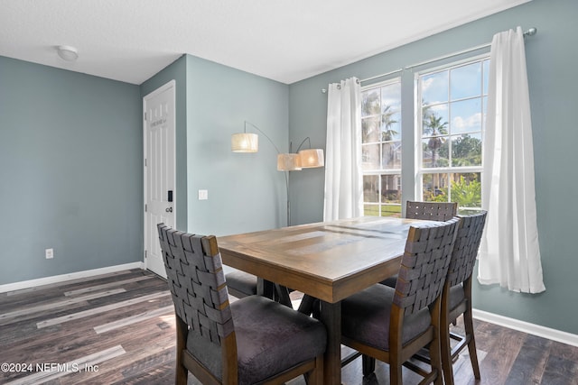 dining area featuring a textured ceiling and dark hardwood / wood-style flooring