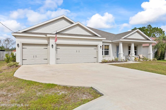 view of front facade featuring a front yard and a garage