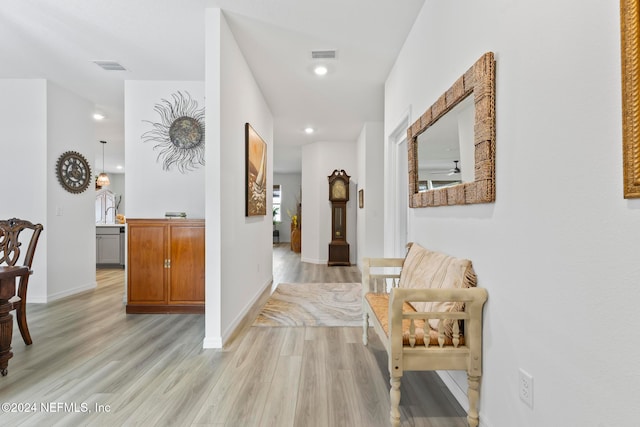 hall with light hardwood / wood-style flooring