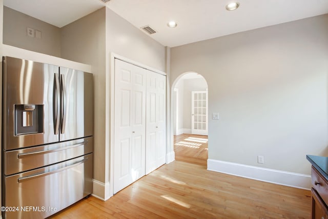 kitchen featuring light hardwood / wood-style flooring and stainless steel refrigerator with ice dispenser