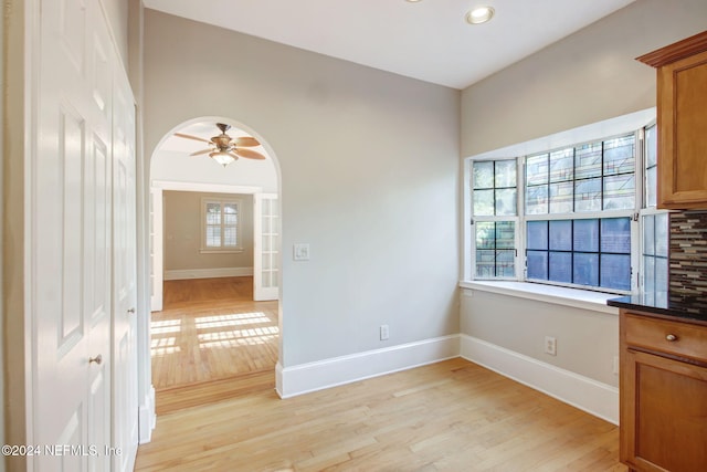 spare room featuring ceiling fan and light wood-type flooring