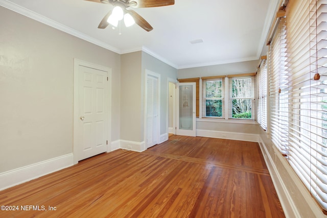 unfurnished room with hardwood / wood-style flooring, crown molding, and ceiling fan