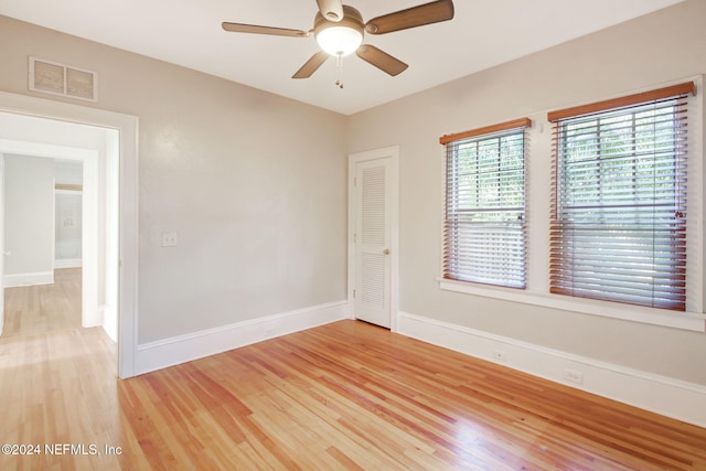 spare room featuring wood-type flooring and ceiling fan