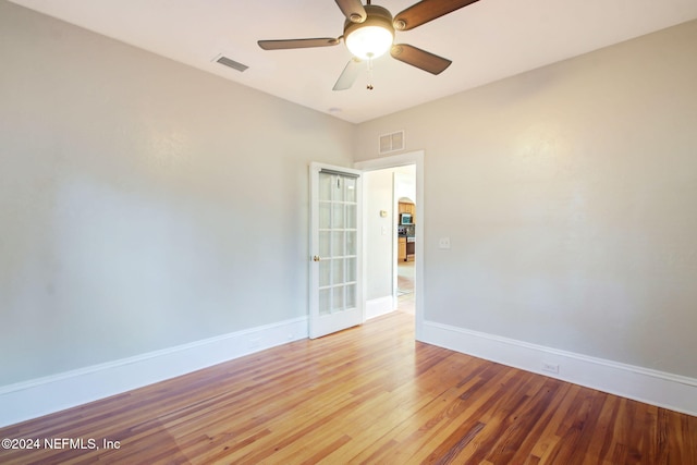 spare room with hardwood / wood-style flooring and ceiling fan