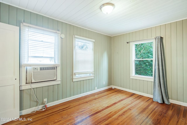 spare room featuring hardwood / wood-style flooring and cooling unit