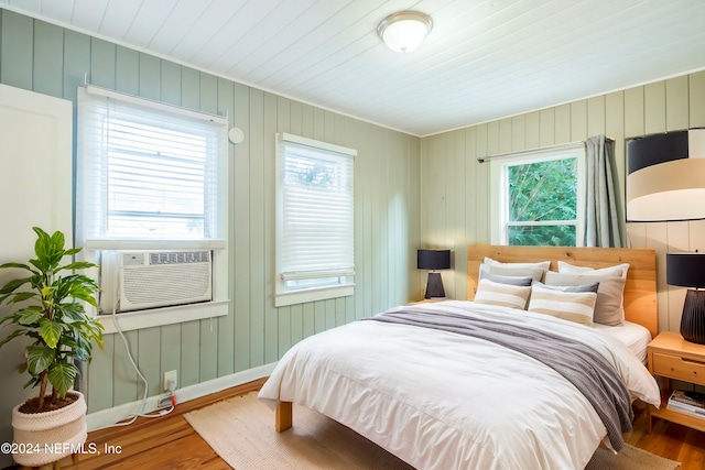 bedroom with wood-type flooring and cooling unit