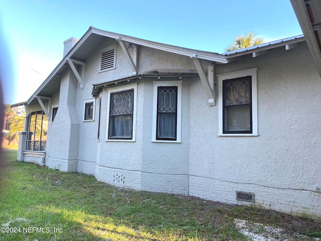 view of side of home featuring a lawn