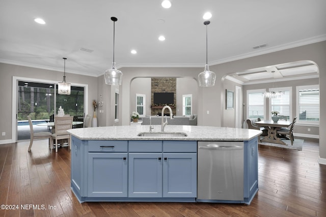 kitchen with stainless steel dishwasher, a wealth of natural light, sink, and an island with sink