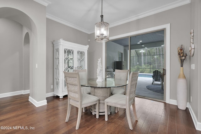 dining space featuring ornamental molding, a chandelier, and dark hardwood / wood-style floors