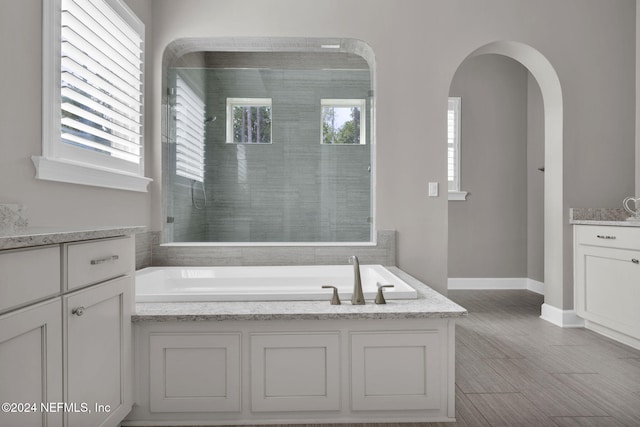 bathroom featuring a washtub and vanity