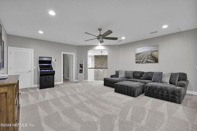 living room with ceiling fan and light colored carpet