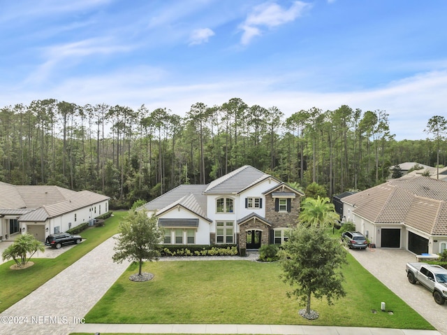 view of front of house featuring a garage and a front yard