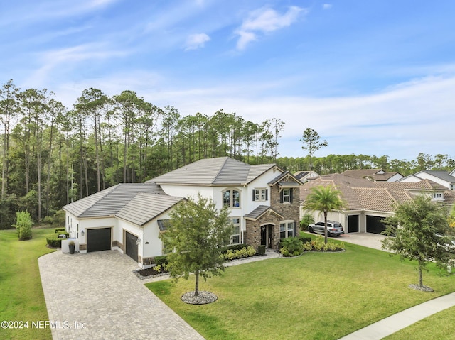 view of front of home with a garage and a front yard