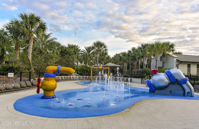 view of swimming pool featuring a playground