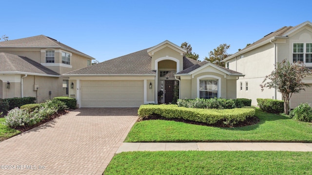 front facade featuring a garage and a front yard