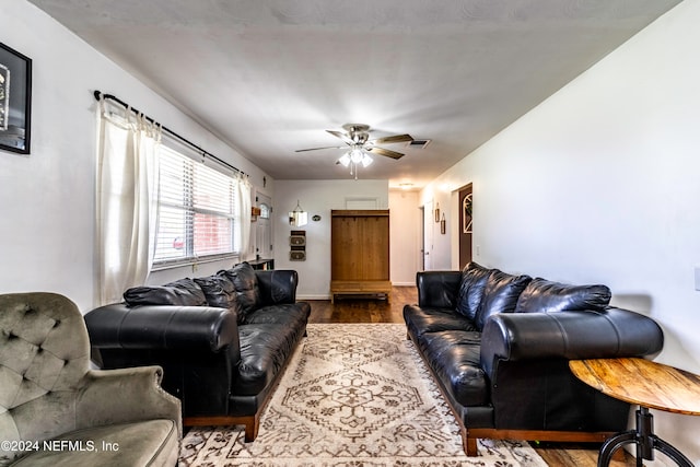 living room featuring ceiling fan and hardwood / wood-style flooring