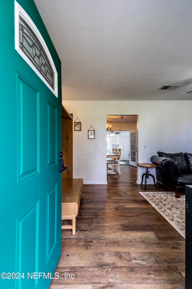 entryway featuring dark hardwood / wood-style floors and a notable chandelier