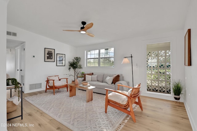 living room with light hardwood / wood-style floors and ceiling fan