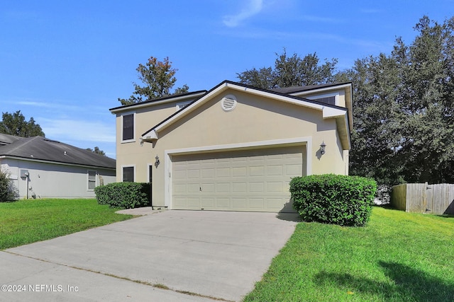 view of front of home with a front yard and a garage