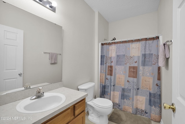 bathroom featuring toilet, vanity, a textured ceiling, and a shower with shower curtain