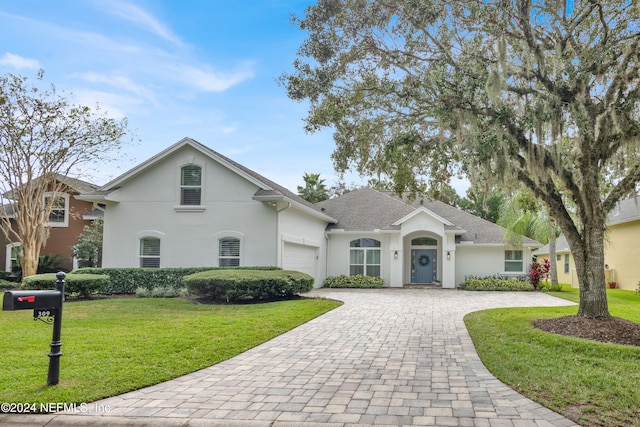 view of front facade with a front lawn and a garage