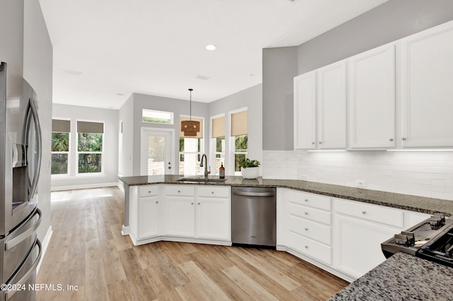 kitchen with white cabinets, a healthy amount of sunlight, appliances with stainless steel finishes, and sink