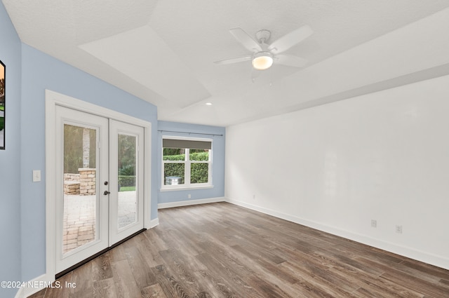 spare room featuring a textured ceiling, wood-type flooring, ceiling fan, and french doors