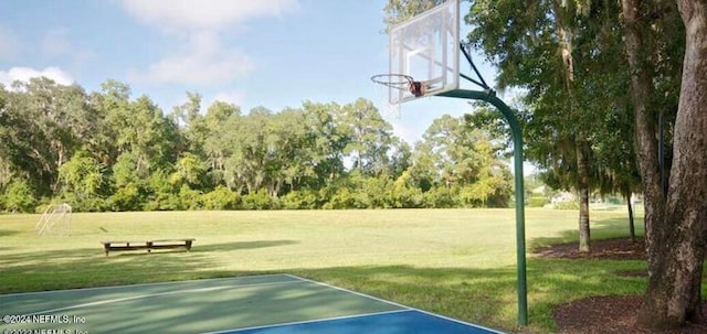 view of basketball court with a lawn